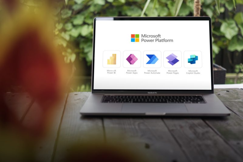 Microsoft power platform family icons, solution for building apps, automating workflows, analyzing data, and creating virtual agents with low code tools, displayed on macbook pro screen