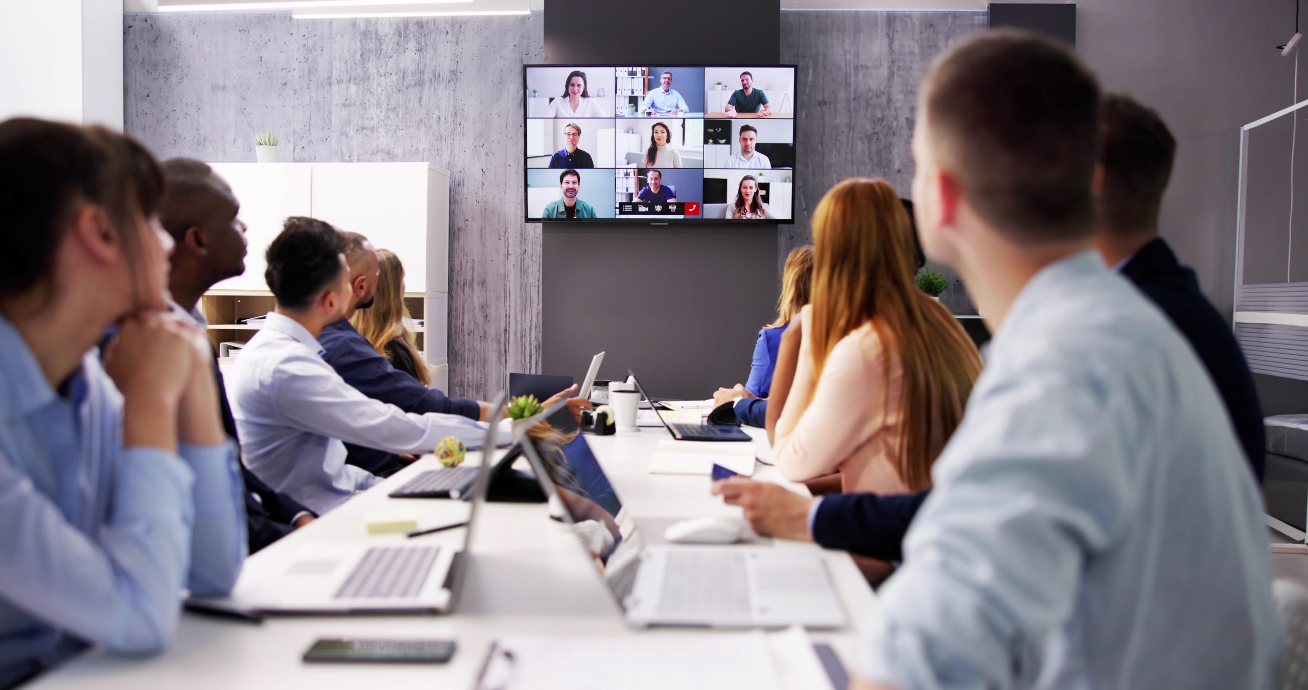 Online video conference call in boardroom meeting